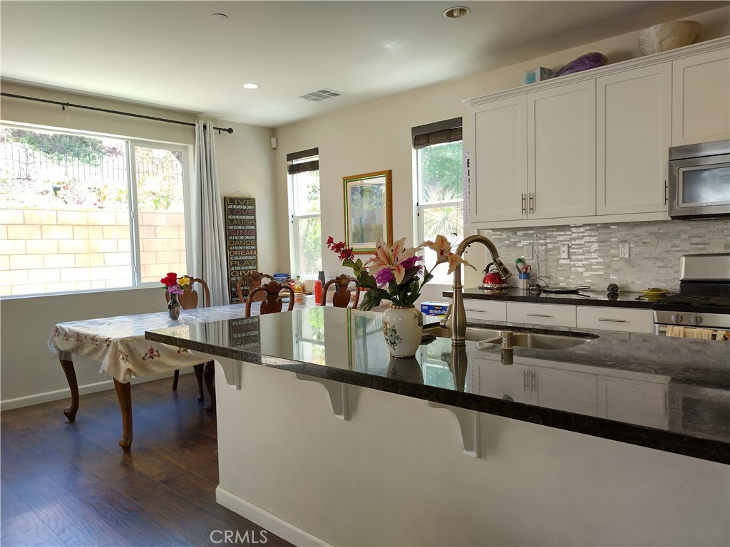 11811 Cramer Road Yucaipa, CA 92399 - Photo 18 of 56 a kitchen with sink table and chairs