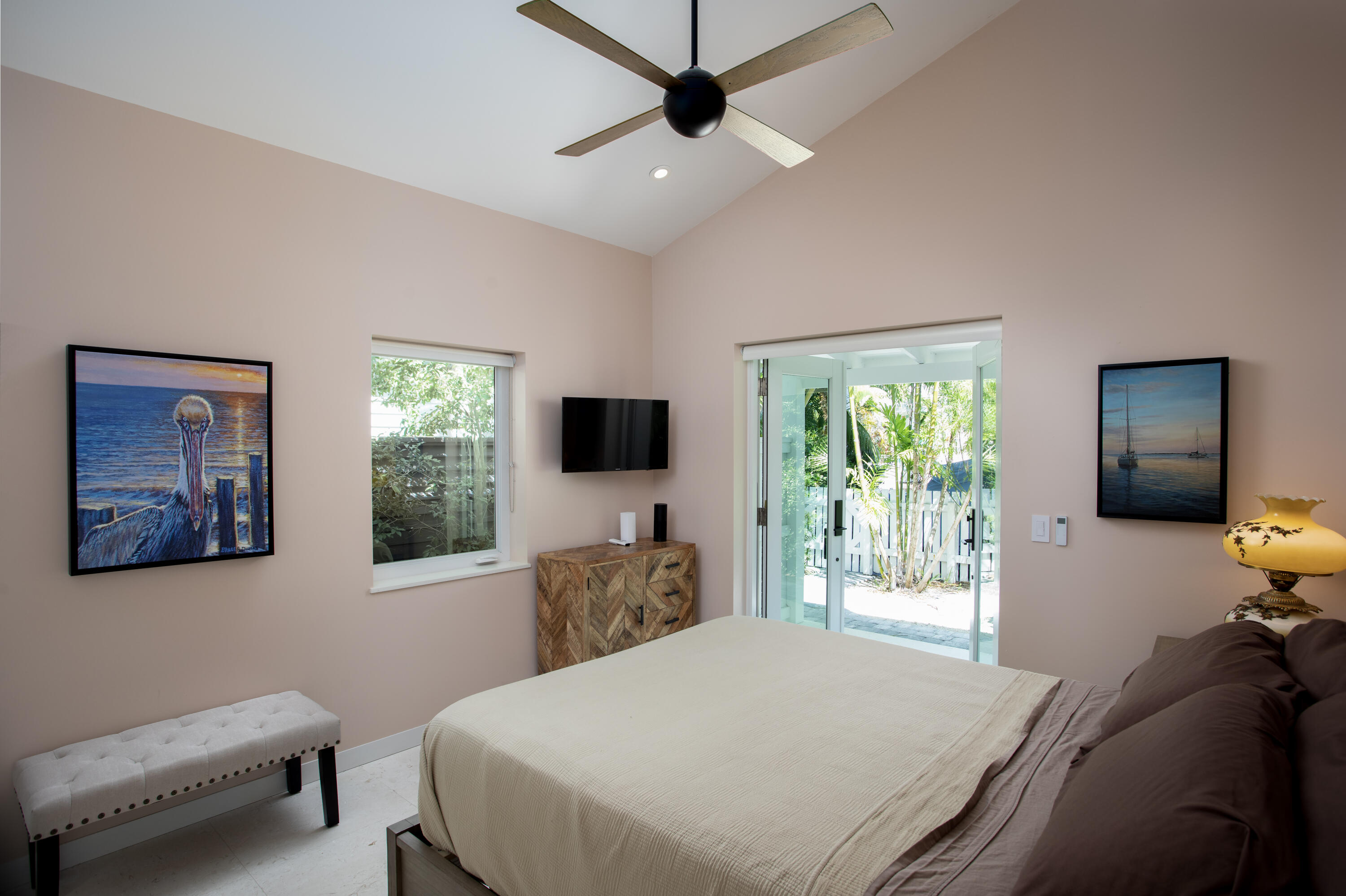 1215 Duncan Street Key West, FL 33040 - Photo 8 of 14 a bedroom with a bed and a flat screen tv