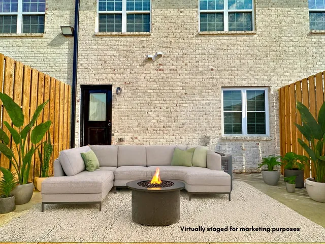 a outdoor living space with furniture and a fireplace