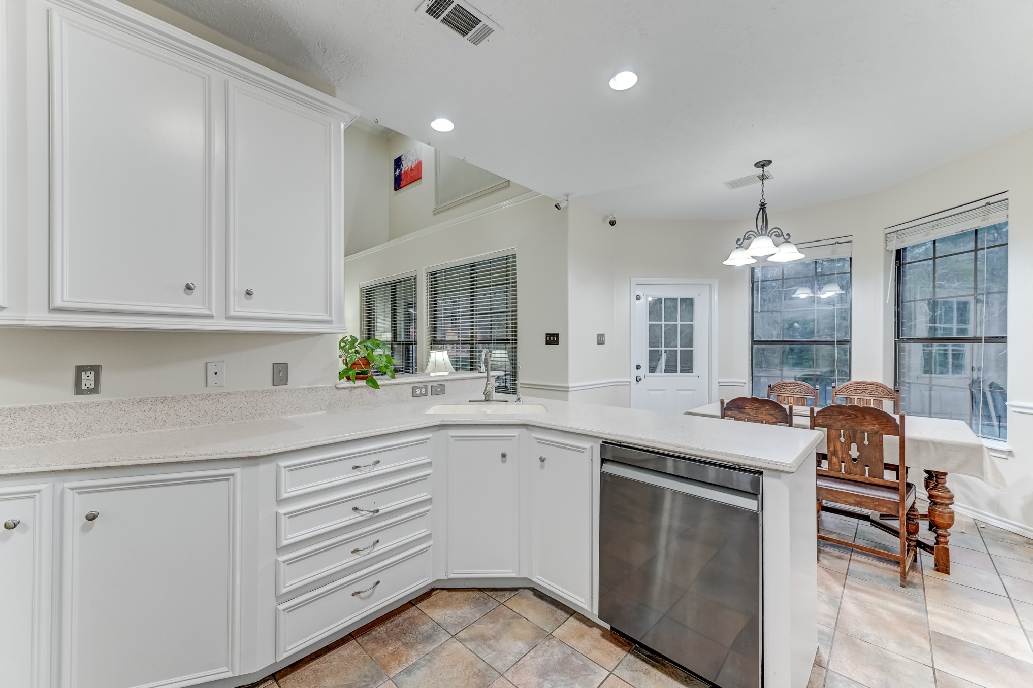 1210 Cherry Creek Road Dayton, TX 77535 - Photo 13 of 50 a kitchen with granite countertop white cabinets and white appliances