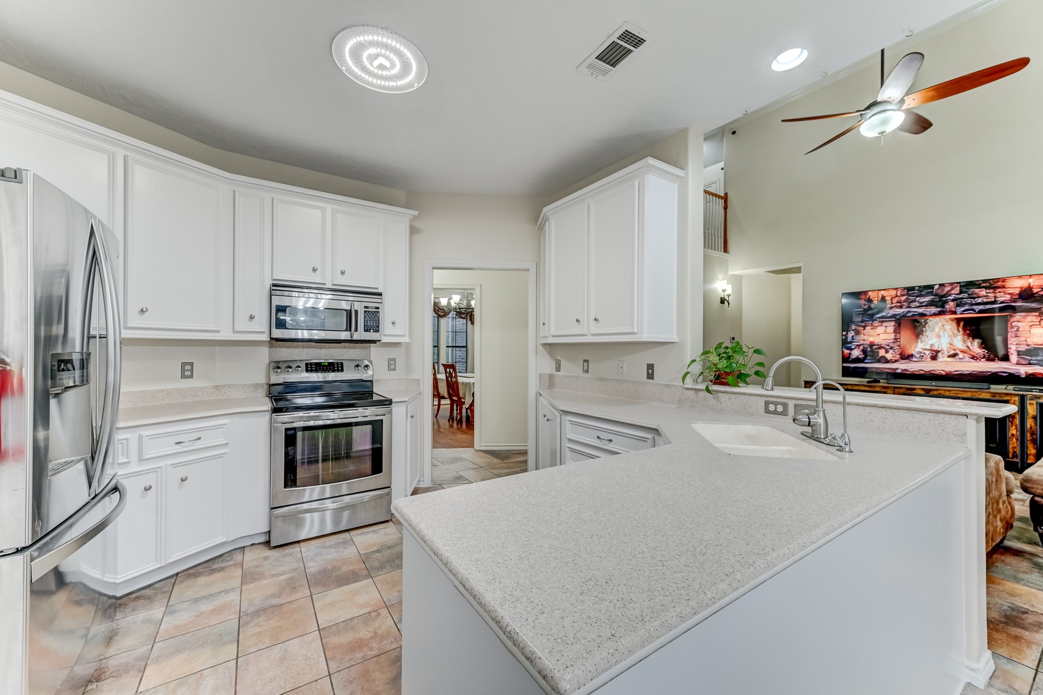 1210 Cherry Creek Road Dayton, TX 77535 - Photo 14 of 50 a kitchen with stainless steel appliances a stove refrigerator sink and cabinets