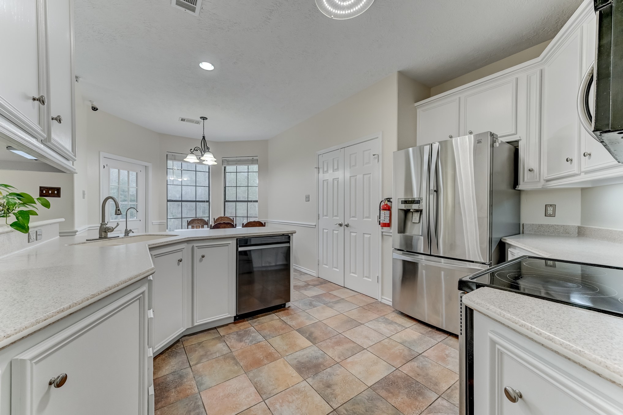 1210 Cherry Creek Road Dayton, TX 77535 - Photo 15 of 50 a kitchen with refrigerator and cabinets