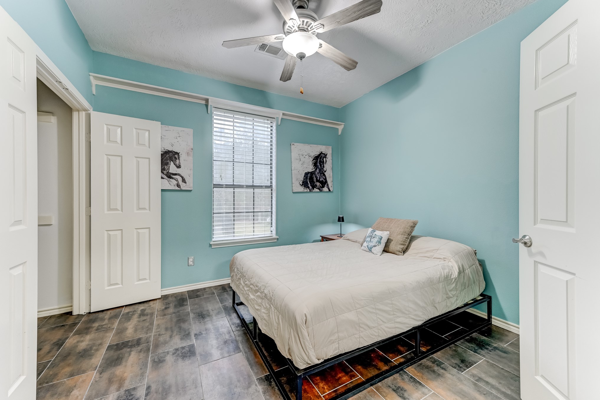 1210 Cherry Creek Road Dayton, TX 77535 - Photo 17 of 50 a bedroom with a bed and a chandelier