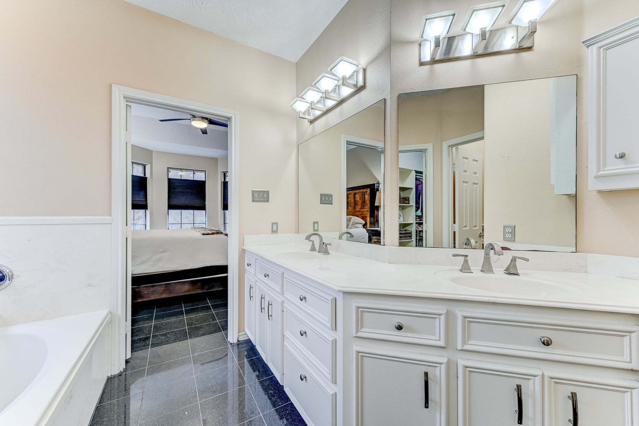 1210 Cherry Creek Road Dayton, TX 77535 - Photo 26 of 50 a spacious en suite bathroom with a double vanity sink a large mirror and a bathtub