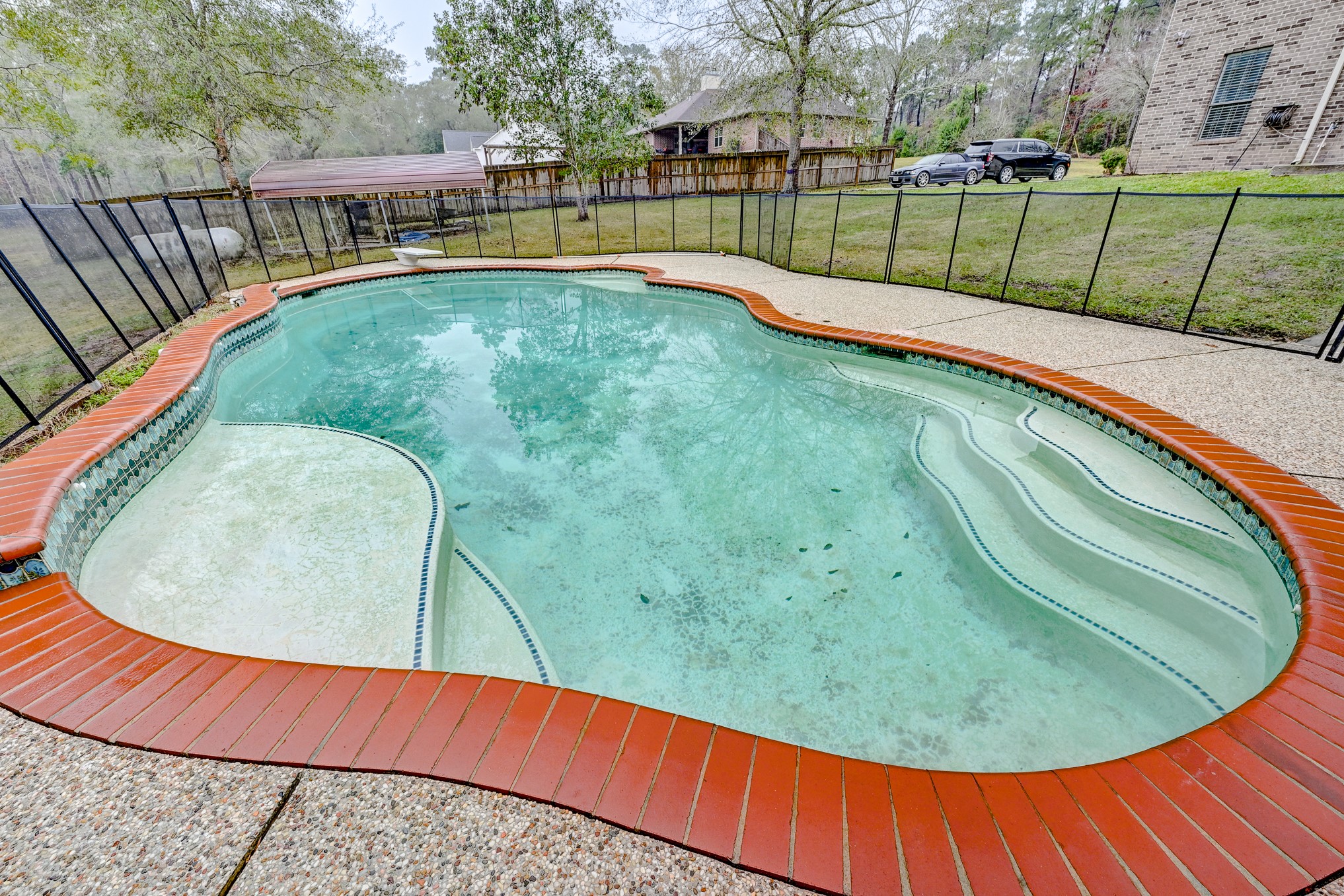1210 Cherry Creek Road Dayton, TX 77535 - Photo 47 of 50 a view of a backyard with a swimming pool