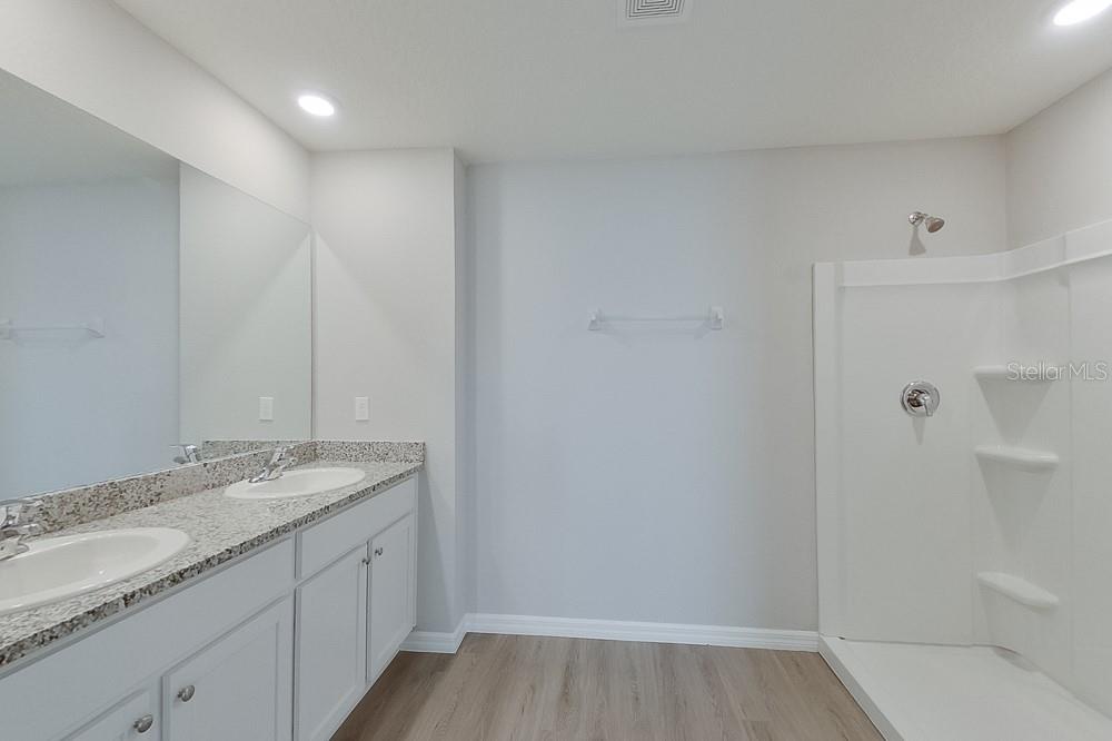 4397 Southwest 85th Lane Ocala, FL 34476 - Photo 19 of 23 a bathroom with a granite countertop sink a toilet and shower