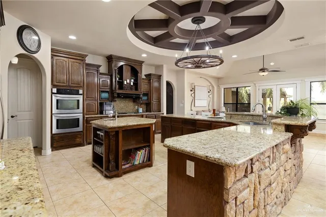 a kitchen with stainless steel appliances granite countertop a stove and a sink