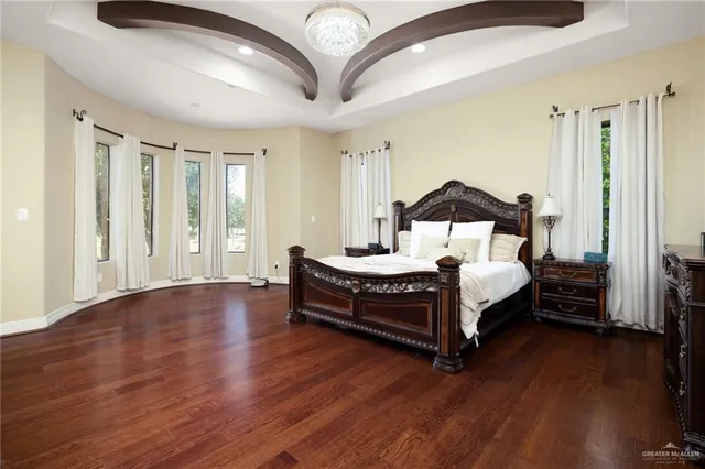 a bedroom with a bed lamp closet and large window