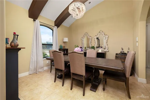a view of a dining room with furniture and a chandelier