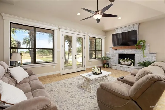 a living room with furniture a flat screen tv and a fireplace