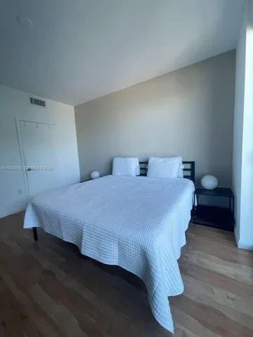 a bedroom with a bed and a lamp