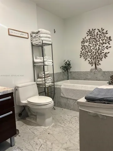 a bathroom with a toilet a sink and a bathtub