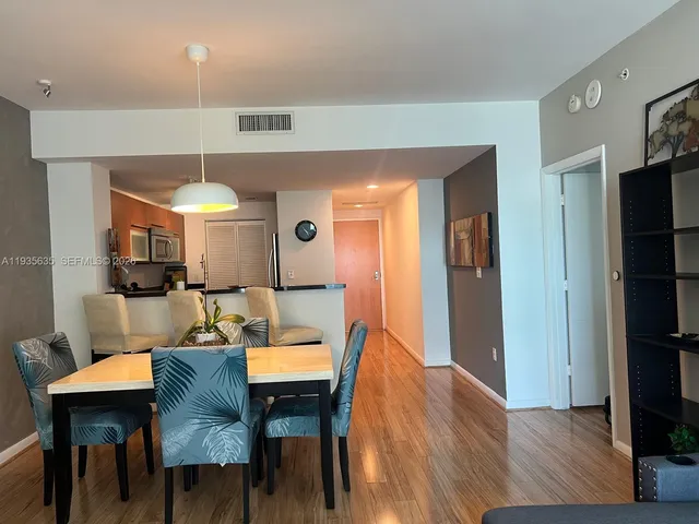a view of a dining room with furniture and wooden floor