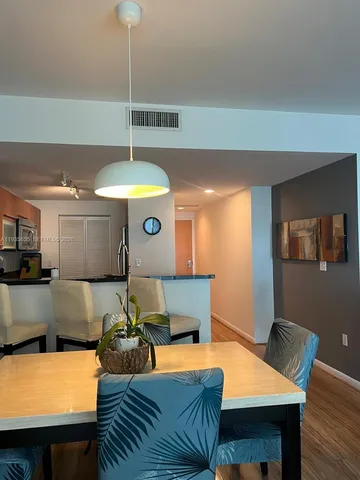 a kitchen with a table chairs and a refrigerator