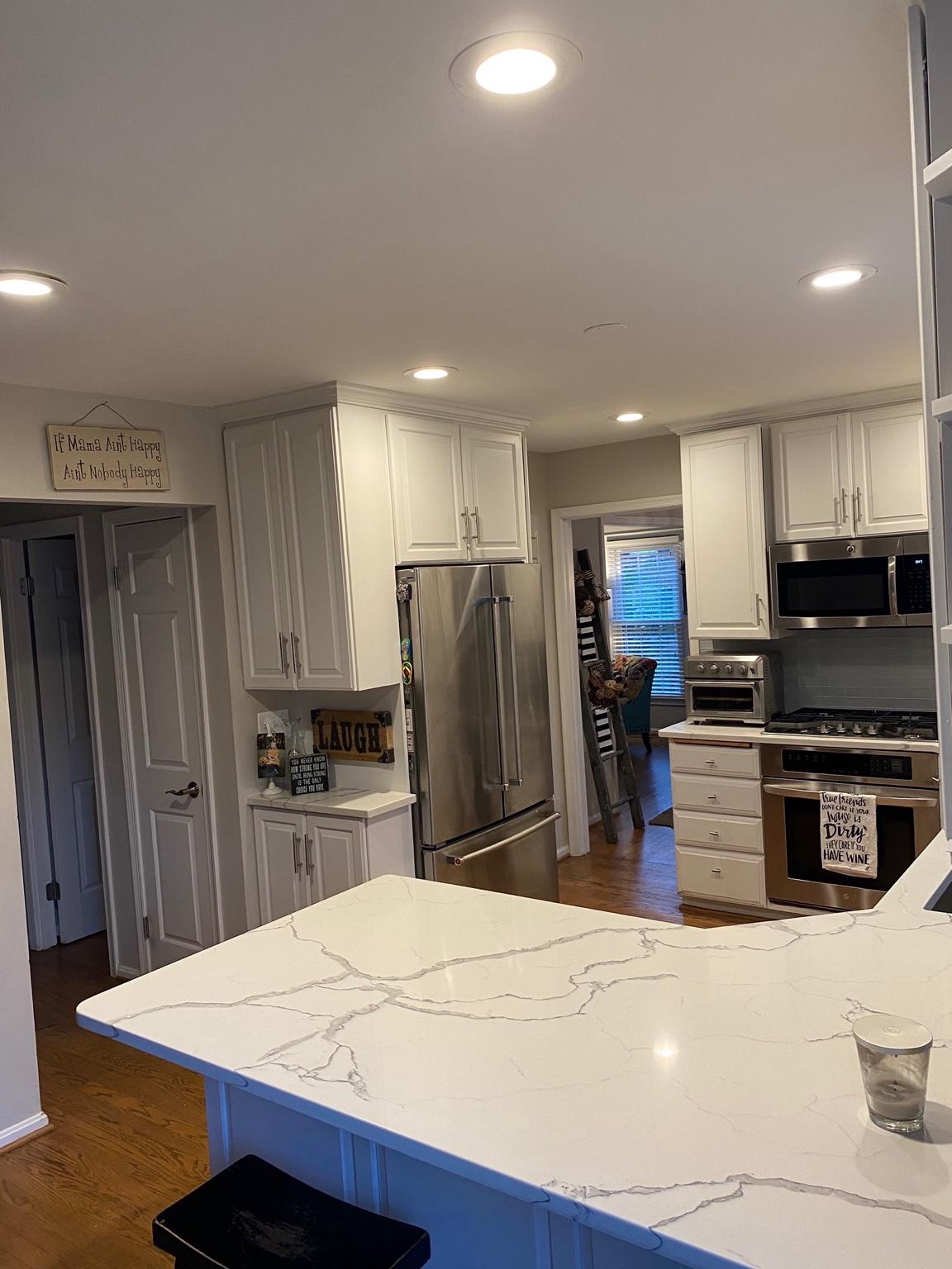 5423 Rilian Court Burke, VA 22015 - Photo 24 of 67 a kitchen with stainless steel appliances kitchen island granite countertop a refrigerator and a stove top oven