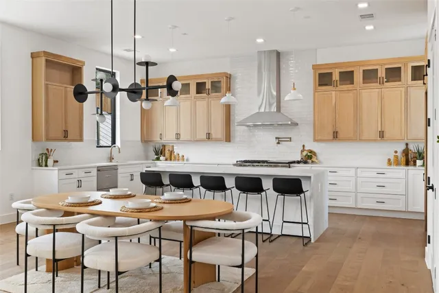 a kitchen with granite countertop white cabinets and chairs
