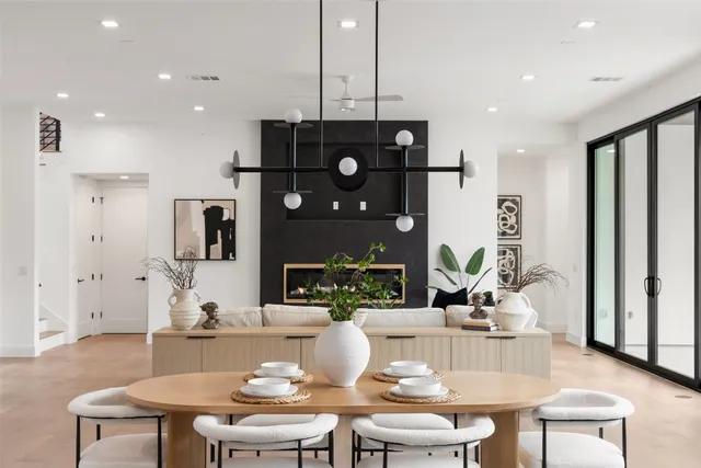 a dining room with furniture a chandelier and wooden floor