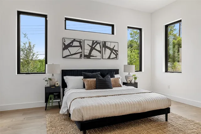 a bedroom with a bed and wooden floor