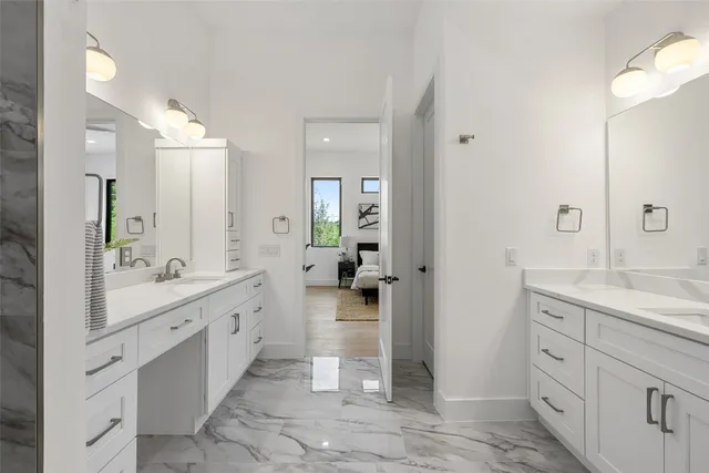 a spacious bathroom with a double vanity sink a and mirror
