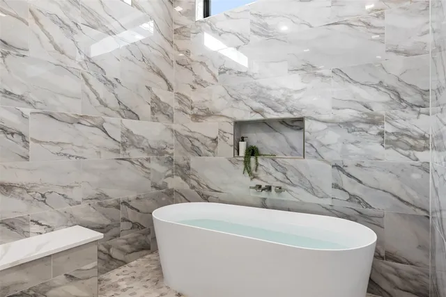 a white bath tub sitting in a bathroom