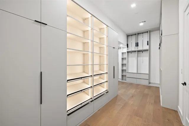 a kitchen with granite countertop white cabinets and a sink