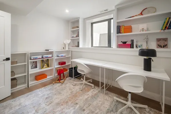 a bathroom with a double vanity sink toilet mirror and shower
