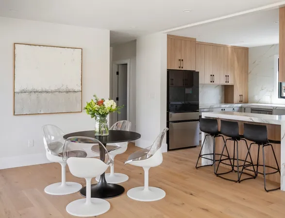 a dining room with furniture and wooden floor