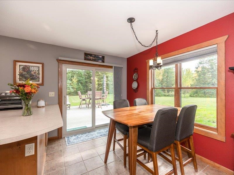 3994 County Rd U South Range, WI 54874 - Photo 19 of 56 Dining area with light tile patterned flooring and a chandelier