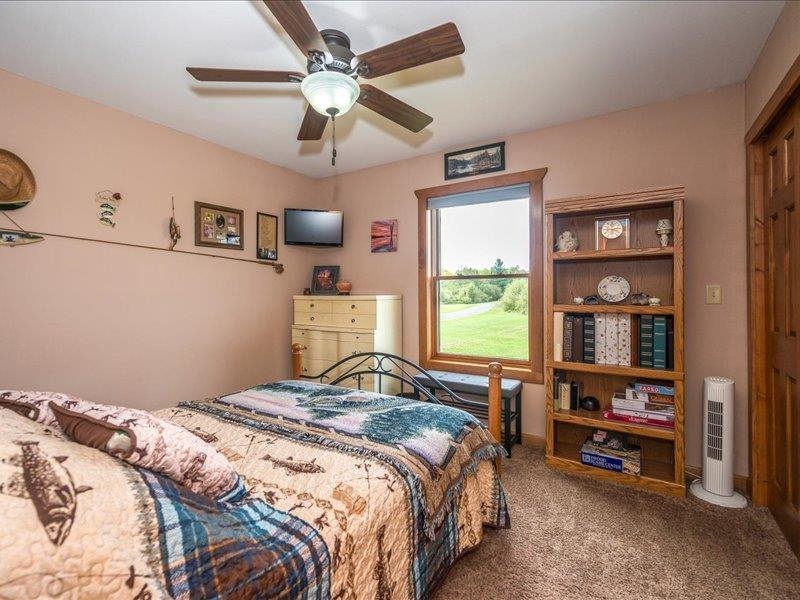 3994 County Rd U South Range, WI 54874 - Photo 26 of 56 Bedroom with dark colored carpet and a ceiling fan