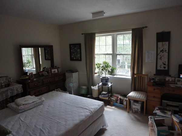 141 Lake Shore Road, Unit 4 Boston, MA 02135 - Photo 11 of 12 a bedroom with a bed a table chair and a window