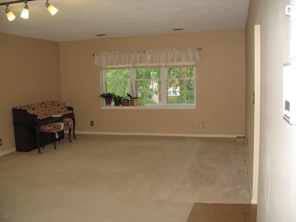 141 Lake Shore Road, Unit 4 Boston, MA 02135 - Photo 5 of 12 an empty room with a window