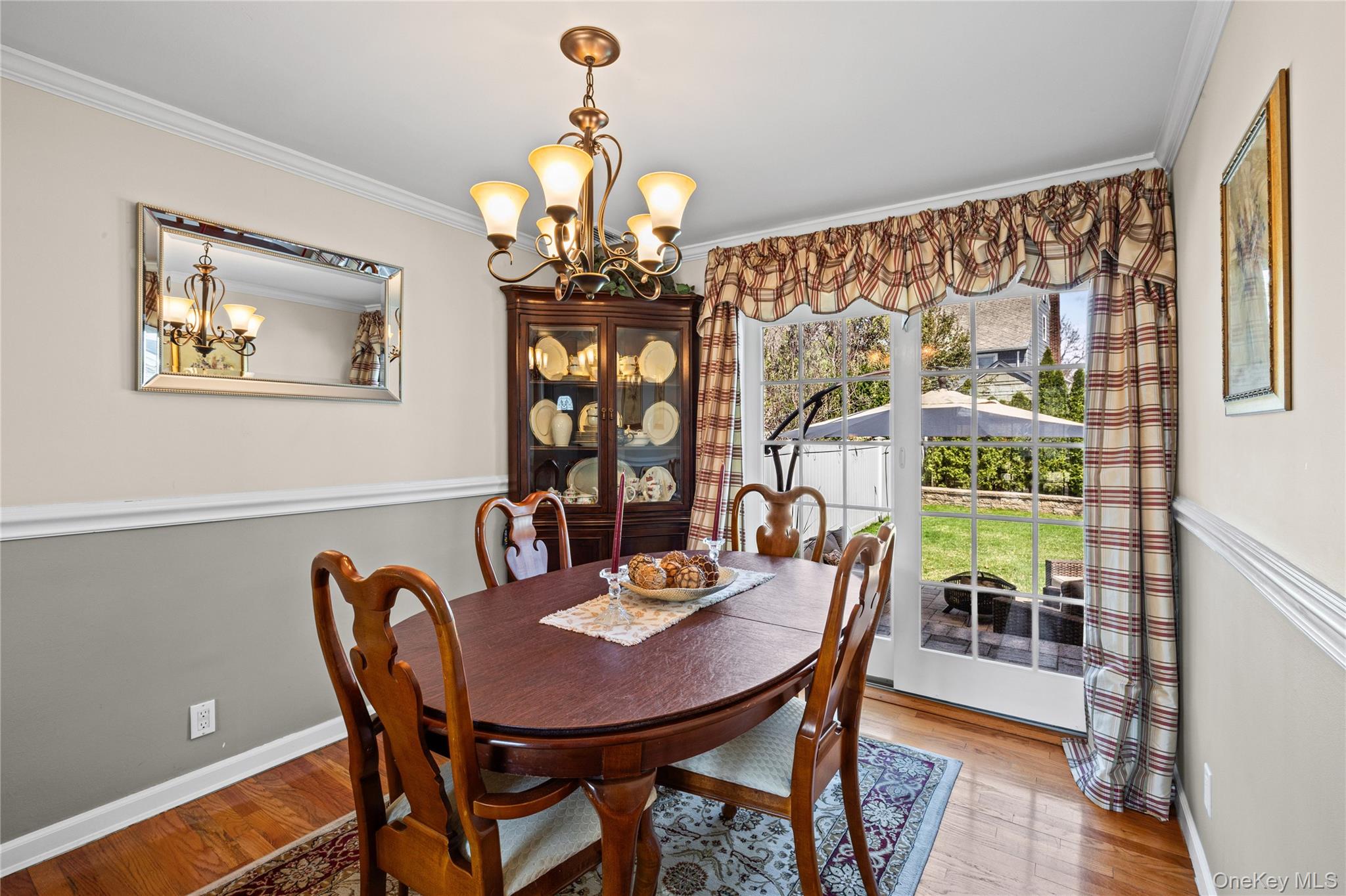 416 Argyle Road Mineola, NY 11501 - Photo 17 of 46 a view of a dining room with furniture a chandelier and wooden floor