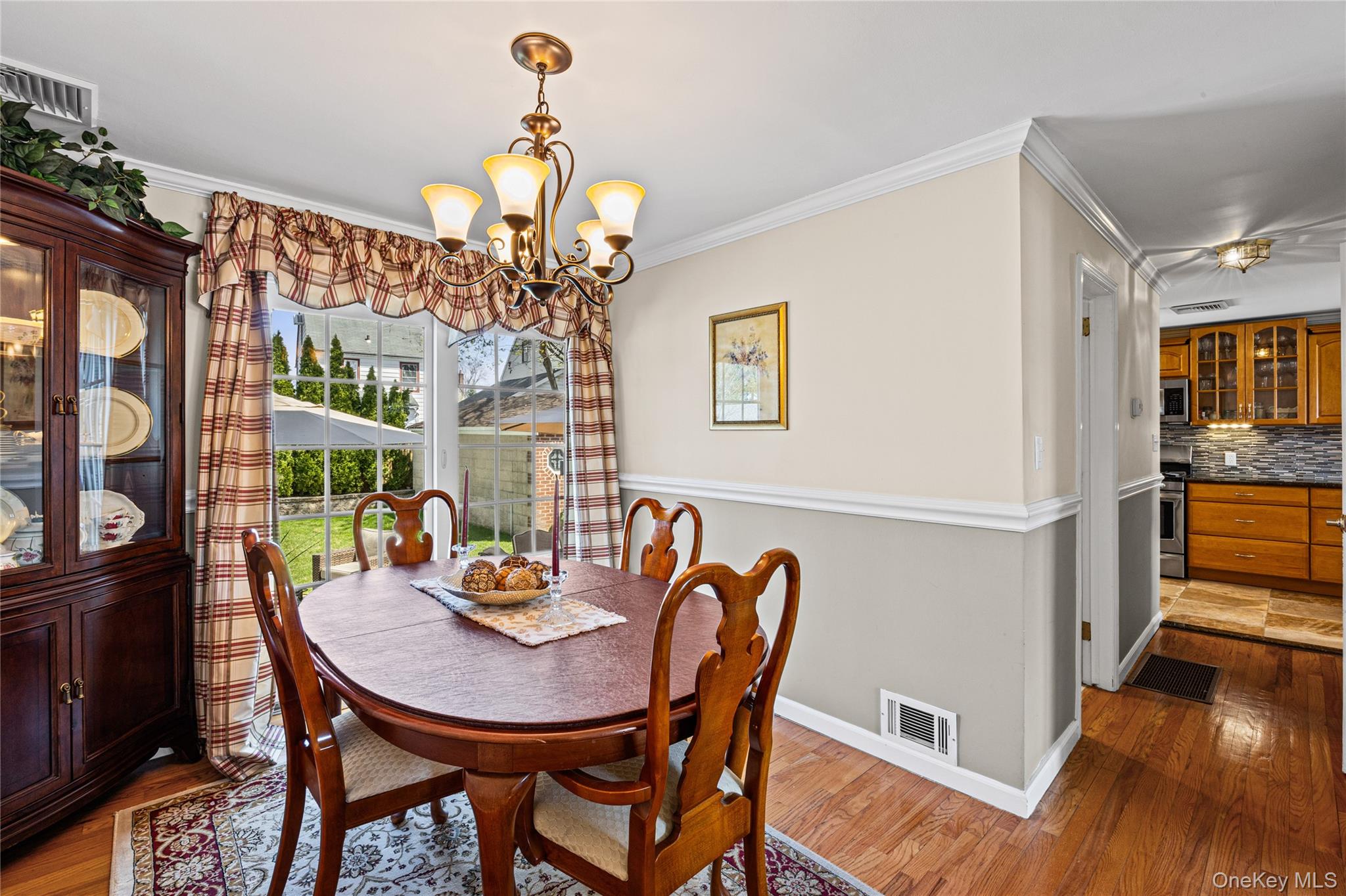 416 Argyle Road Mineola, NY 11501 - Photo 18 of 46 a view of a dining room with furniture a chandelier and wooden floor