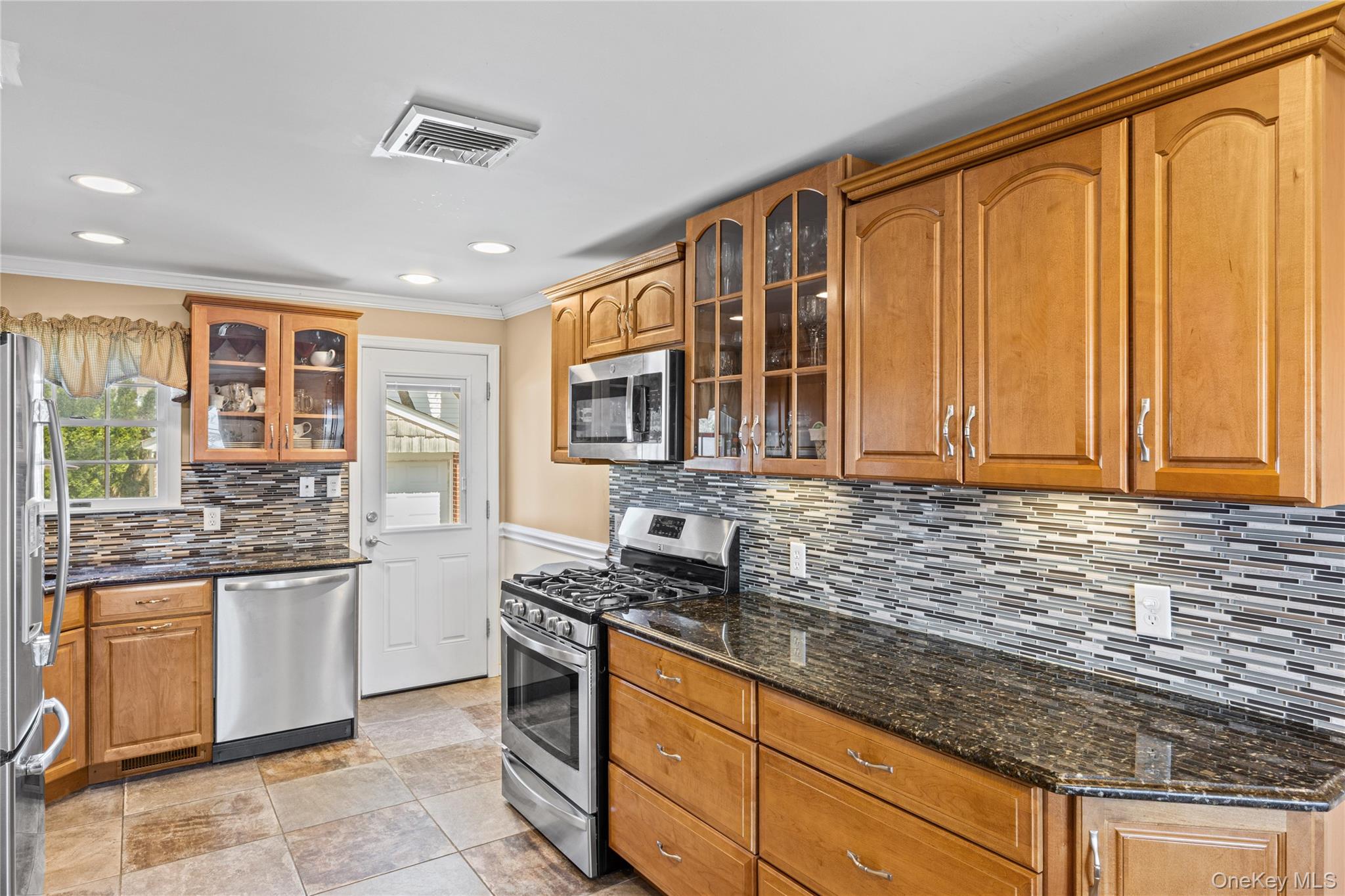 416 Argyle Road Mineola, NY 11501 - Photo 20 of 46 a kitchen with stainless steel appliances granite countertop a stove sink and cabinets