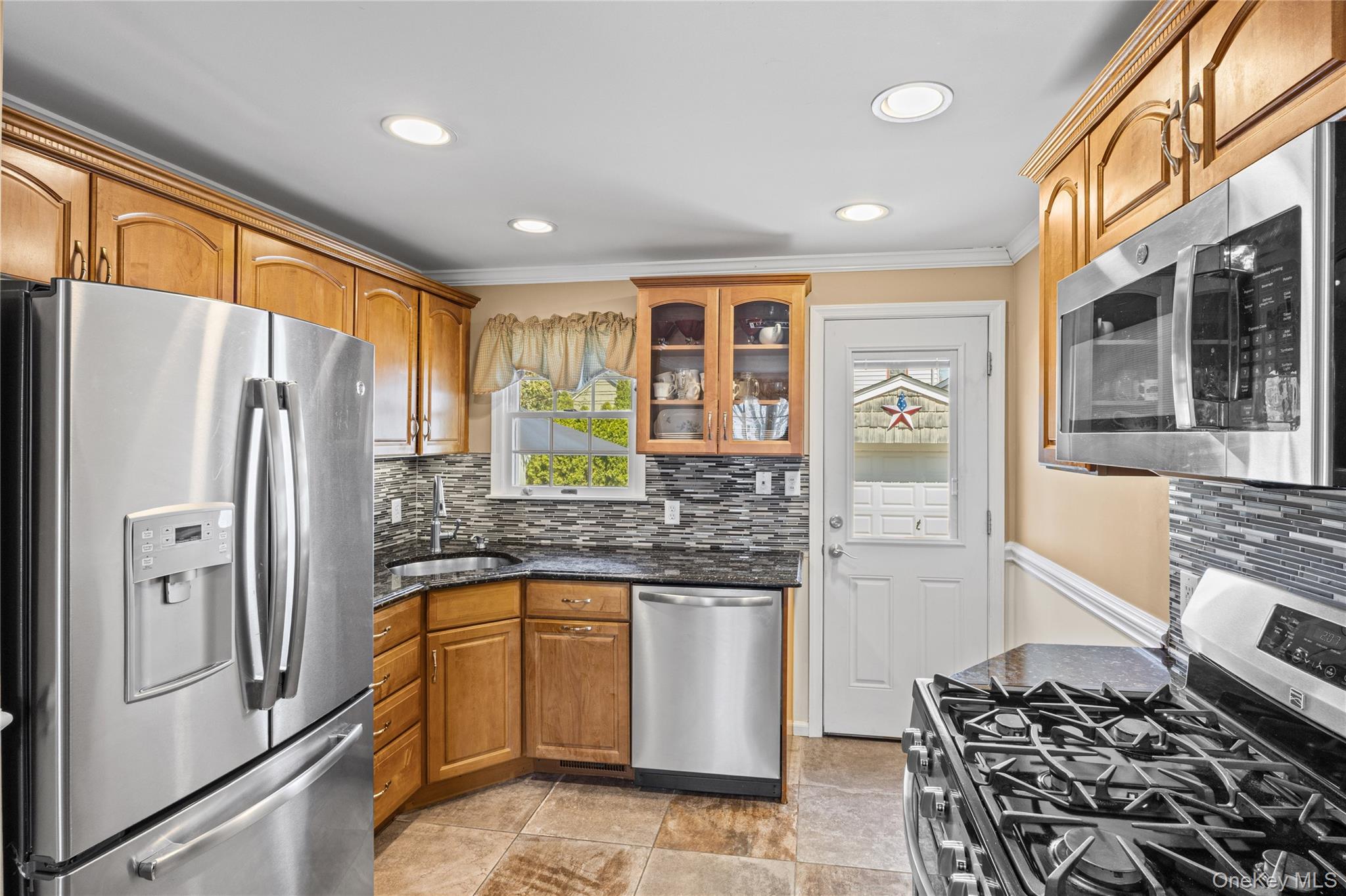 416 Argyle Road Mineola, NY 11501 - Photo 21 of 46 a kitchen with stainless steel appliances granite countertop a refrigerator and a stove top oven