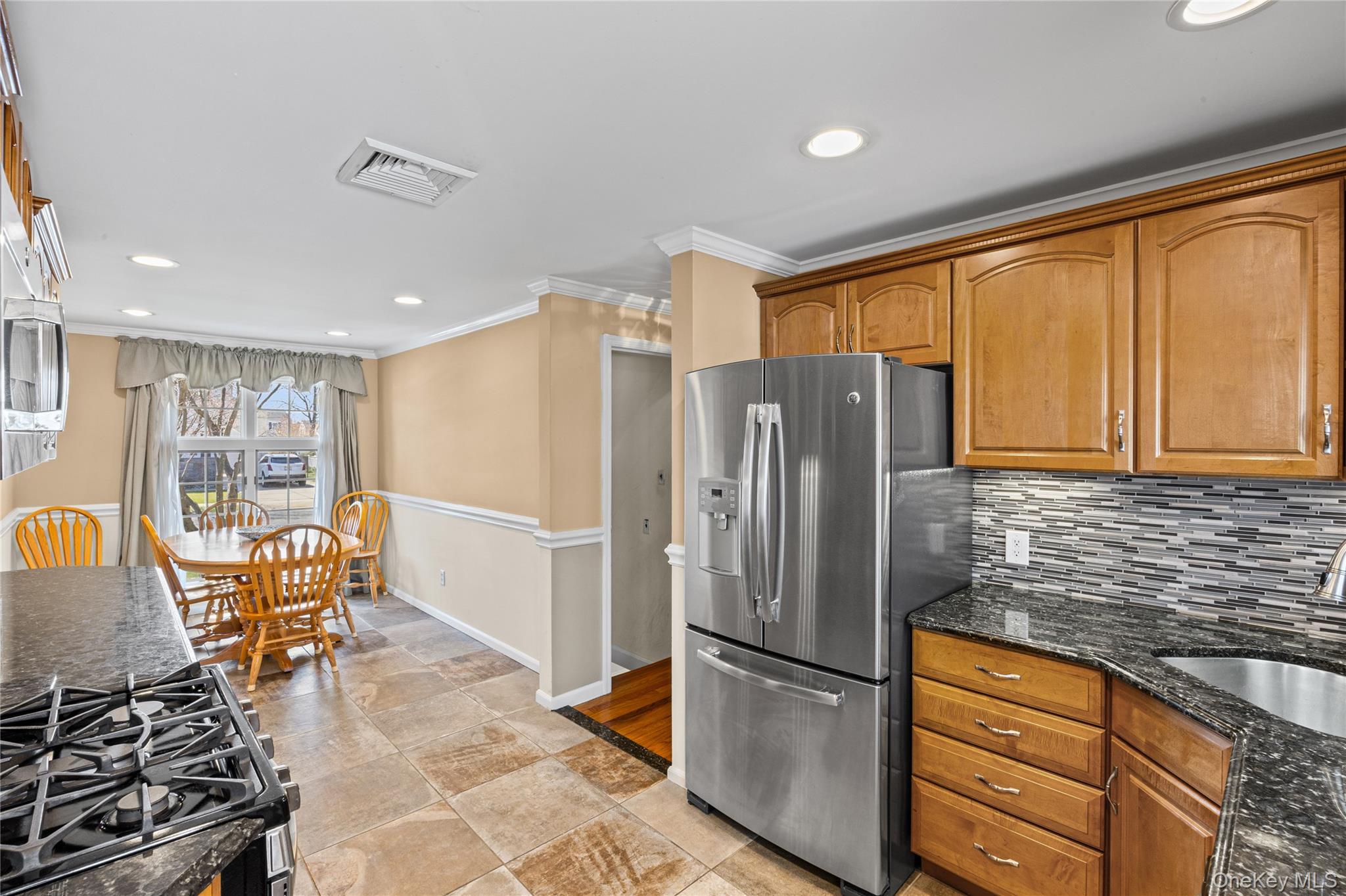 416 Argyle Road Mineola, NY 11501 - Photo 22 of 46 a kitchen with stainless steel appliances granite countertop a refrigerator and a stove top oven