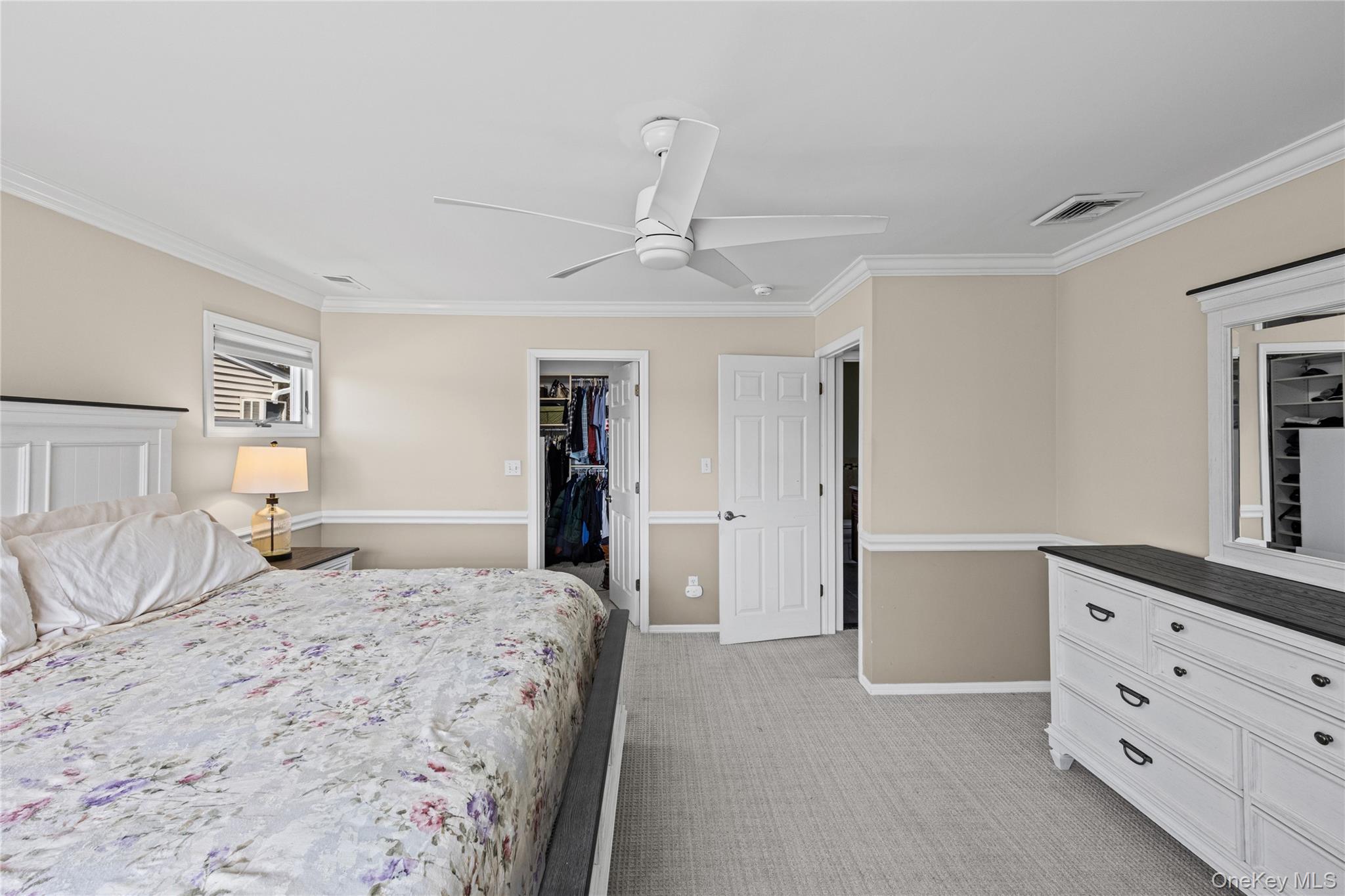 416 Argyle Road Mineola, NY 11501 - Photo 29 of 46 a bedroom with a large bed and a chandelier