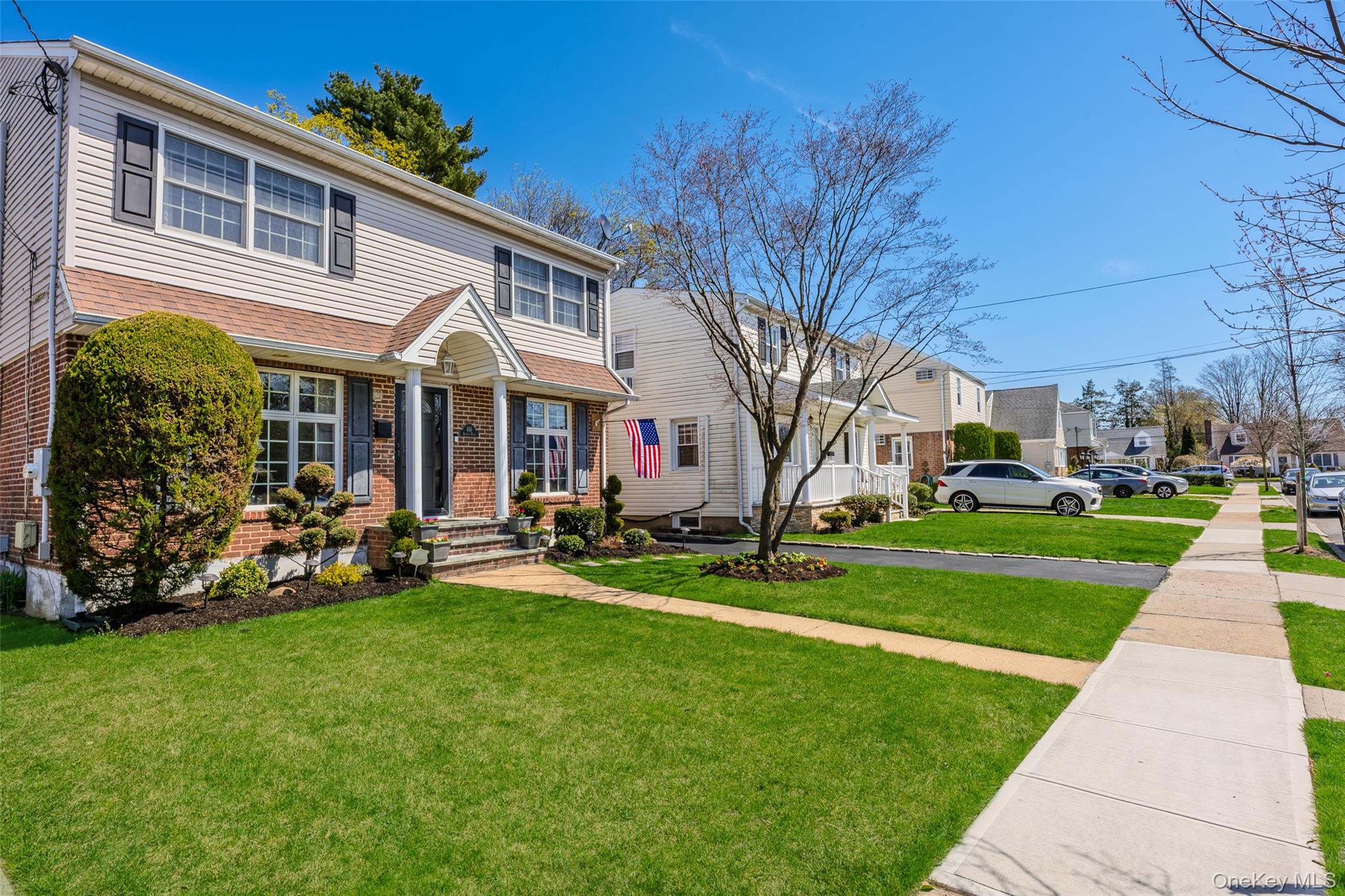 416 Argyle Road Mineola, NY 11501 - Photo 3 of 46 a front view of a house with garden and porch