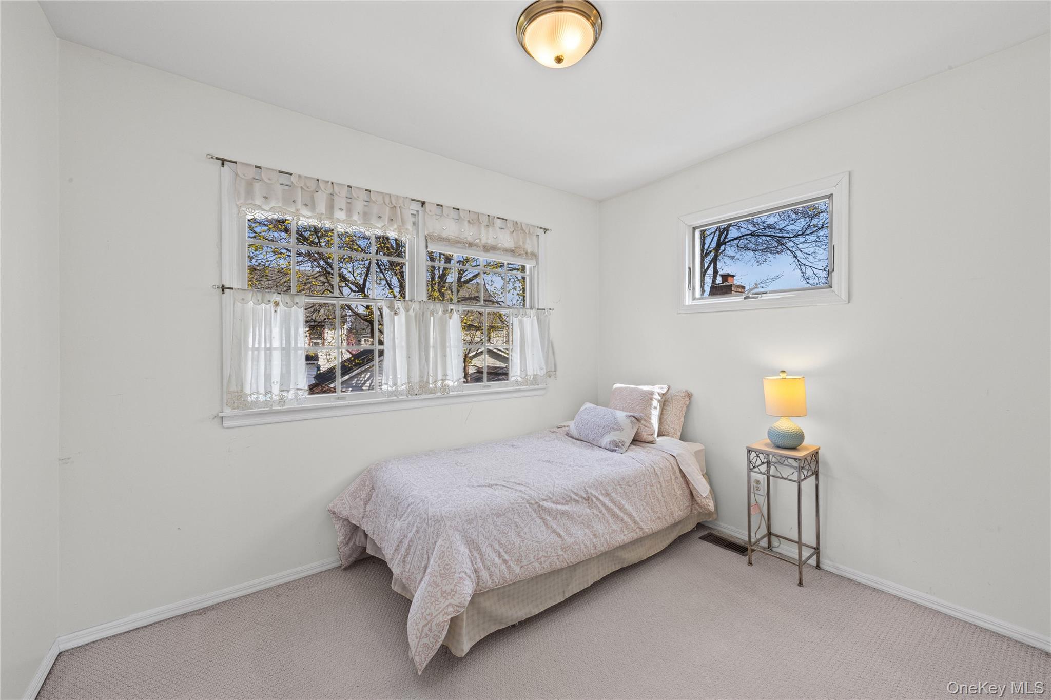 416 Argyle Road Mineola, NY 11501 - Photo 31 of 46 a bedroom with a bed and wall painting