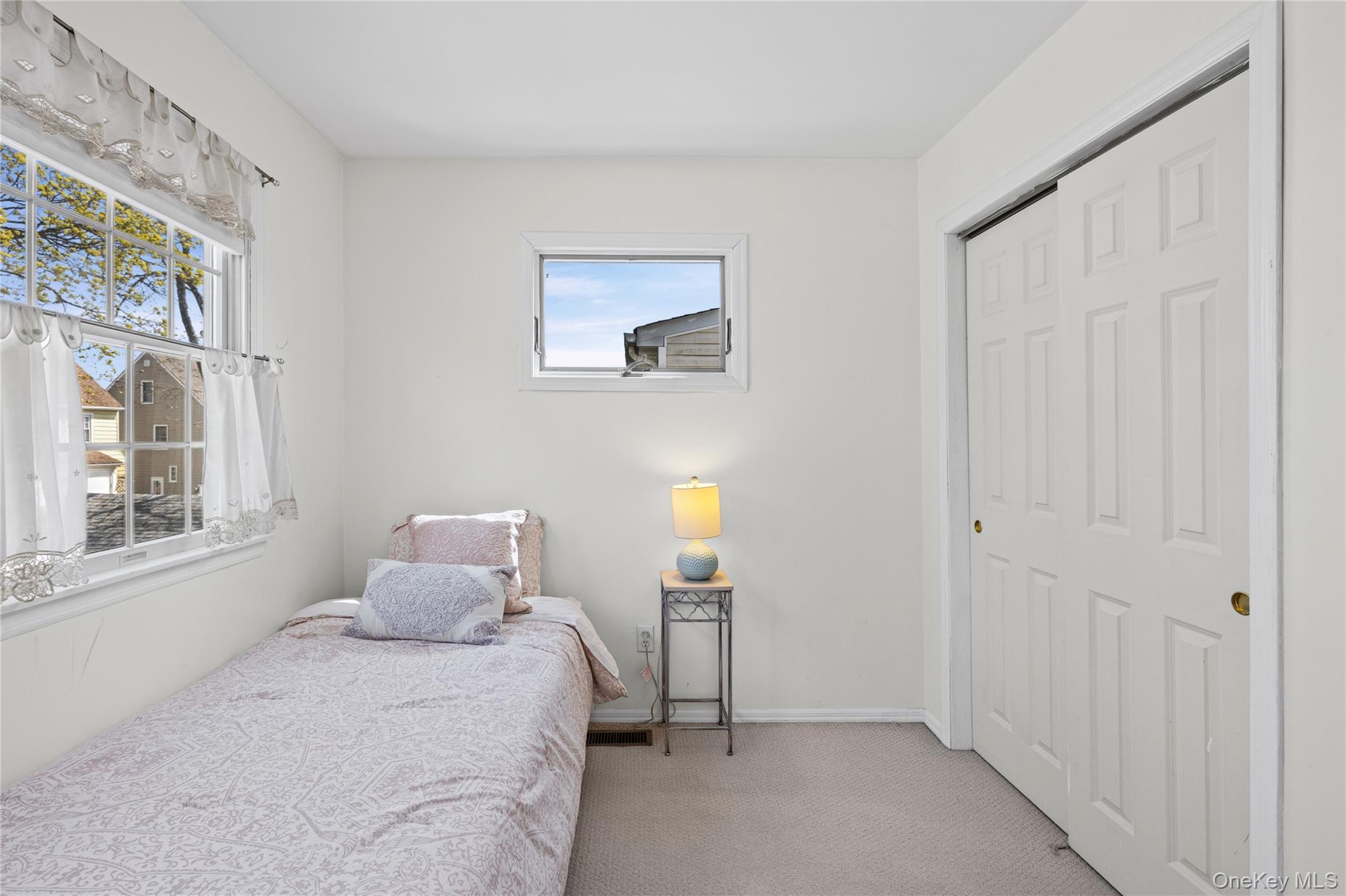 416 Argyle Road Mineola, NY 11501 - Photo 32 of 46 a bedroom with a bed and a window