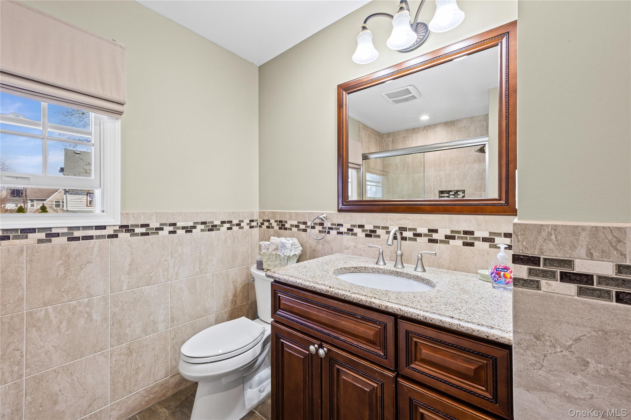 416 Argyle Road Mineola, NY 11501 - Photo 35 of 46 a bathroom with a sink and a mirror with toilet