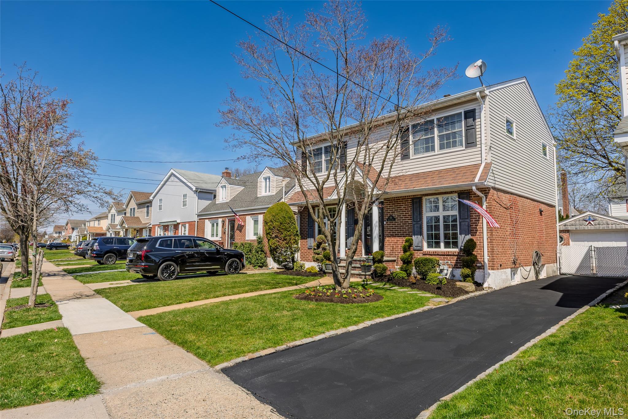 416 Argyle Road Mineola, NY 11501 - Photo 4 of 46 a front view of a building with a garden and plants