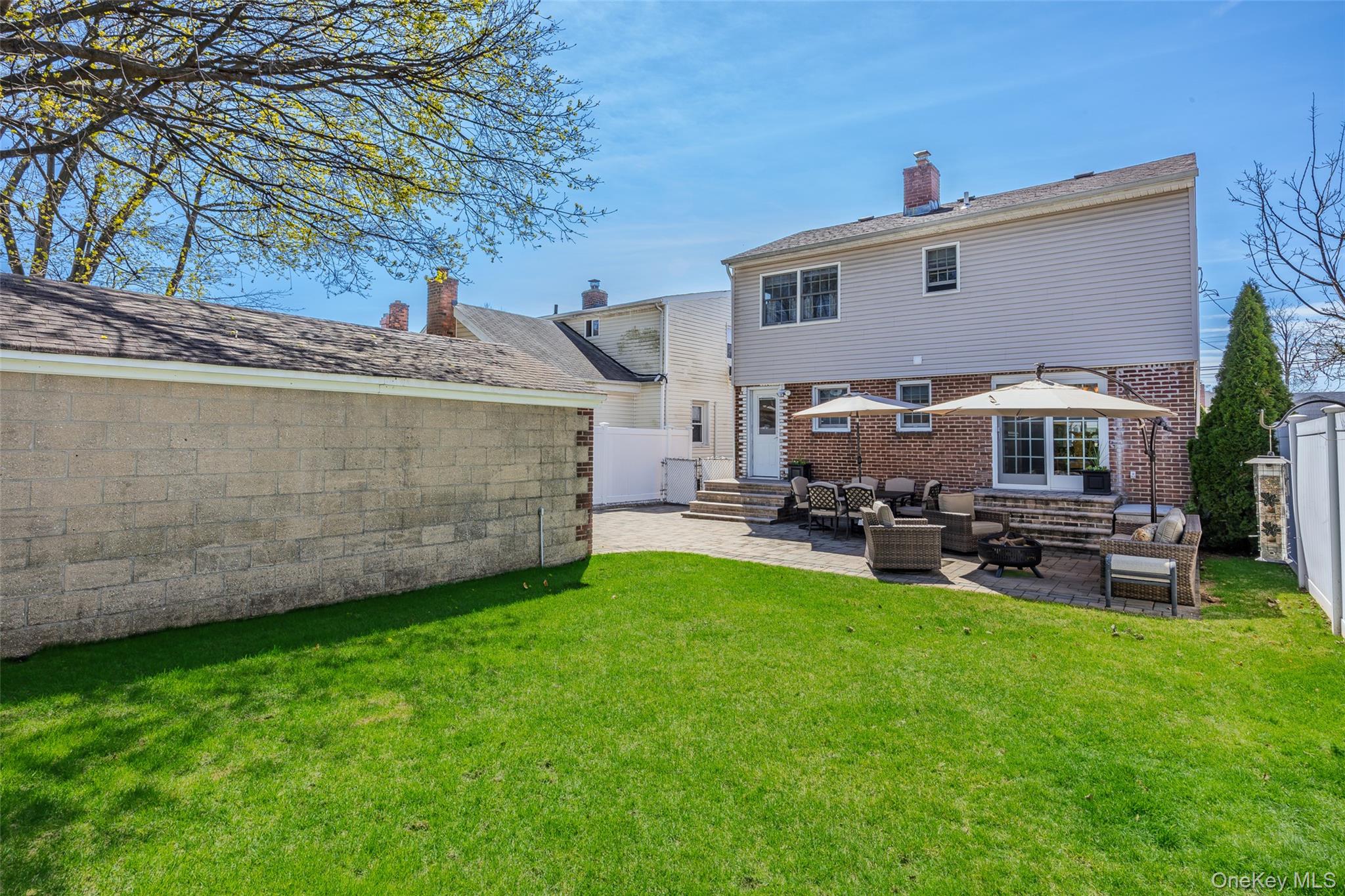 416 Argyle Road Mineola, NY 11501 - Photo 6 of 46 a view of a patio with table and chairs and potted plants