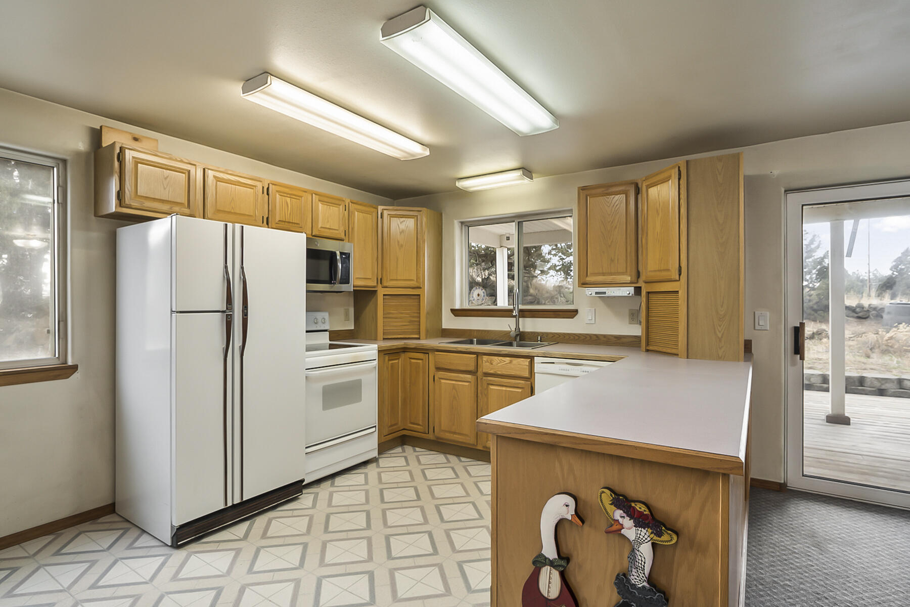 61825 Dobbin Road Bend, OR 97702 - Photo 9 of 43 a kitchen with a refrigerator and a sink