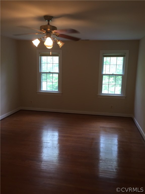 13459 Glendower Road Midlothian, VA 23113 - Photo 12 of 16 an empty room with wooden floor and windows
