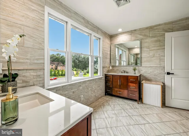 a bathroom with a sink vanity and a mirror