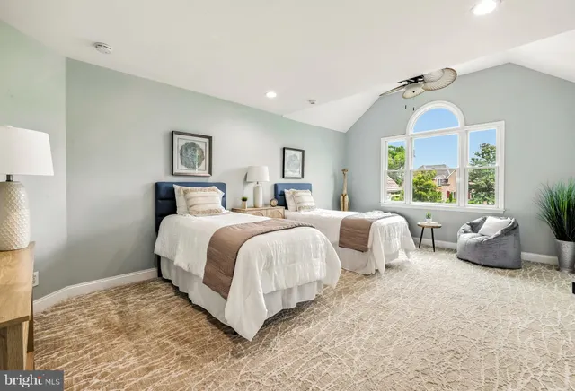 a bed room with two beds and painting on the wall