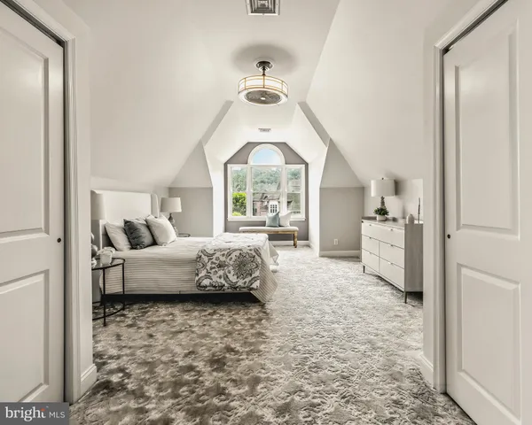 a bedroom with a bed and a dresser in it