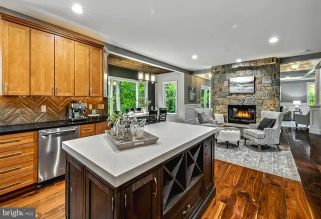 a kitchen with stainless steel appliances granite countertop sink stove top oven and cabinets