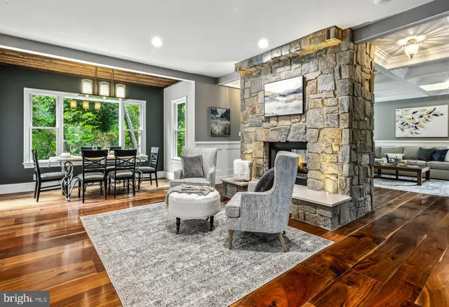 a living room with fireplace furniture and a rug